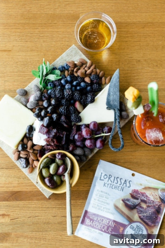 An artfully arranged charcuterie board featuring a variety of cheeses, fruits, nuts, and Lorissa's Kitchen protein snacks, served at the event.