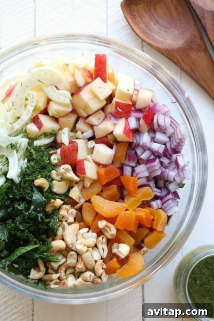 Meal-prep this massaged kale salad for lunch throughout the week! You will get a full serving of fruits, veggies, and fiber! This massaged kale salad will be your new favorite healthy salad. Salad ingredients in a bowl.