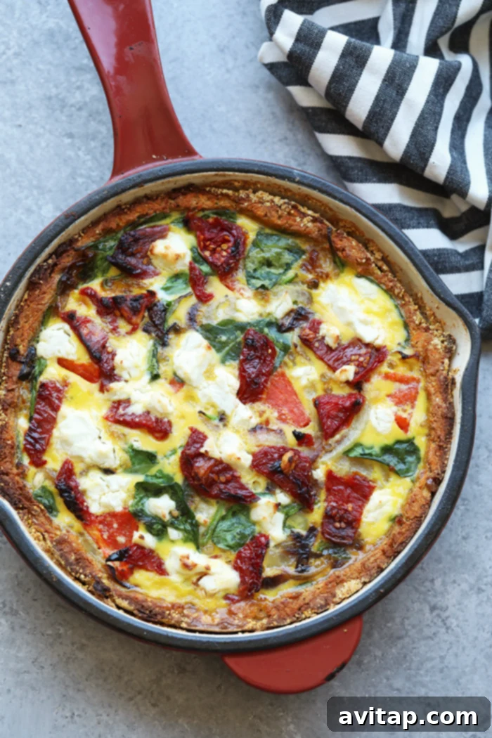 A whole sweet potato crust quiche baked to golden perfection, still in its skillet, ready to be served.
