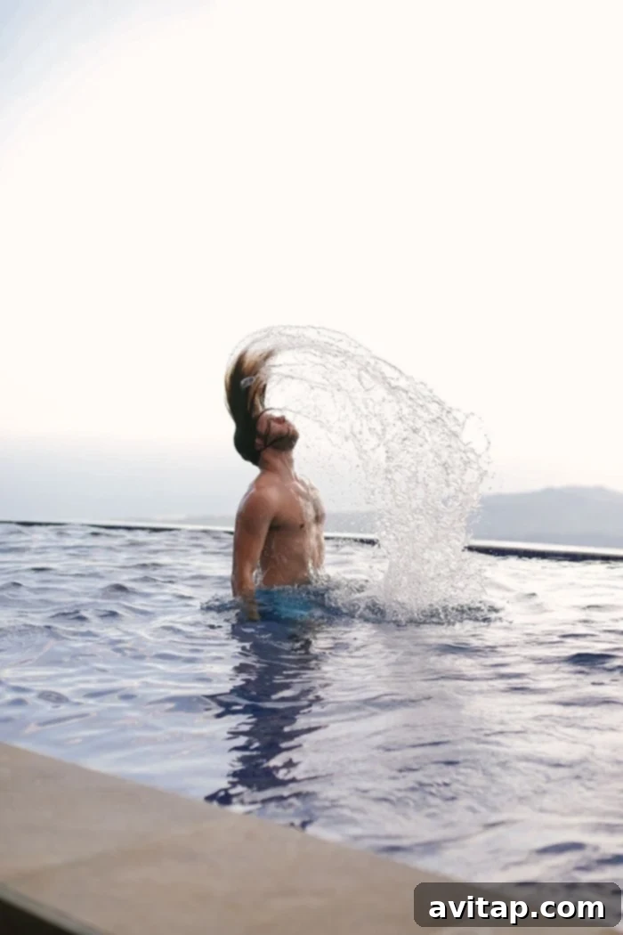 Woman flipping her hair in the infinity pool, capturing a moment of pure joy in Guanacaste