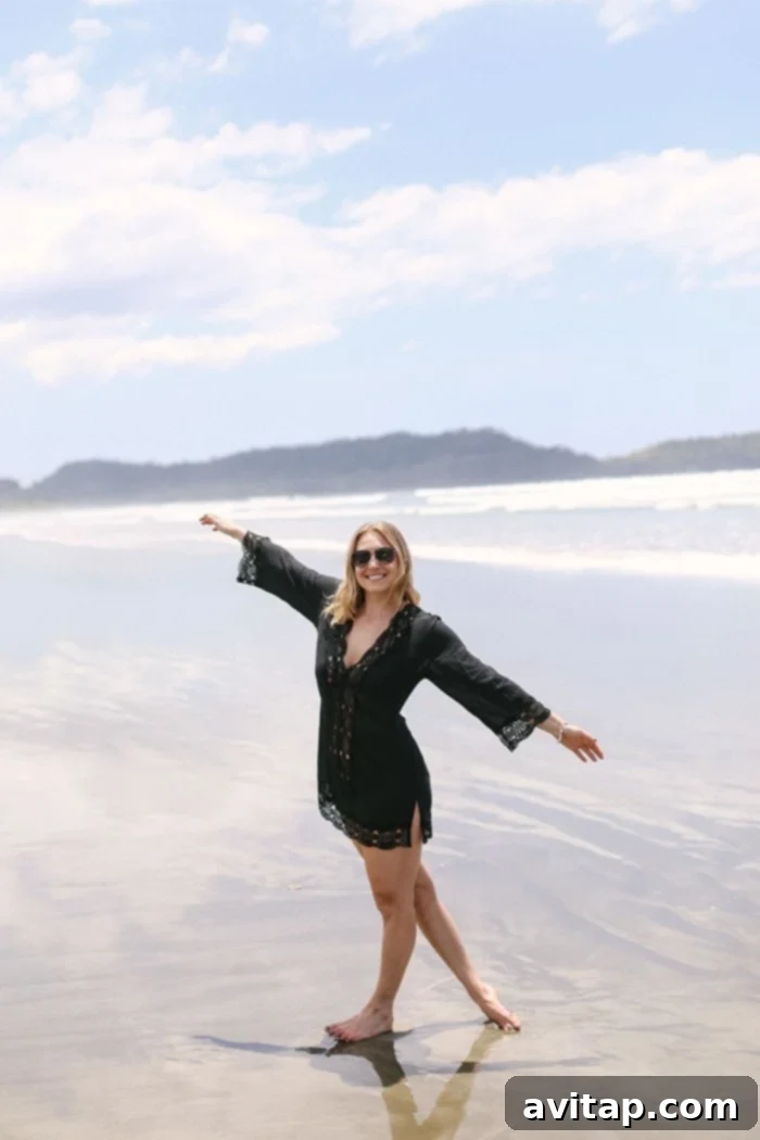 Woman strolling along the pristine, deserted Playa Coyote beach in Costa Rica