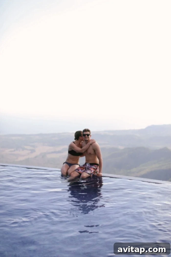 Couple enjoying the infinity pool overlooking a stunning Costa Rican landscape with ocean views