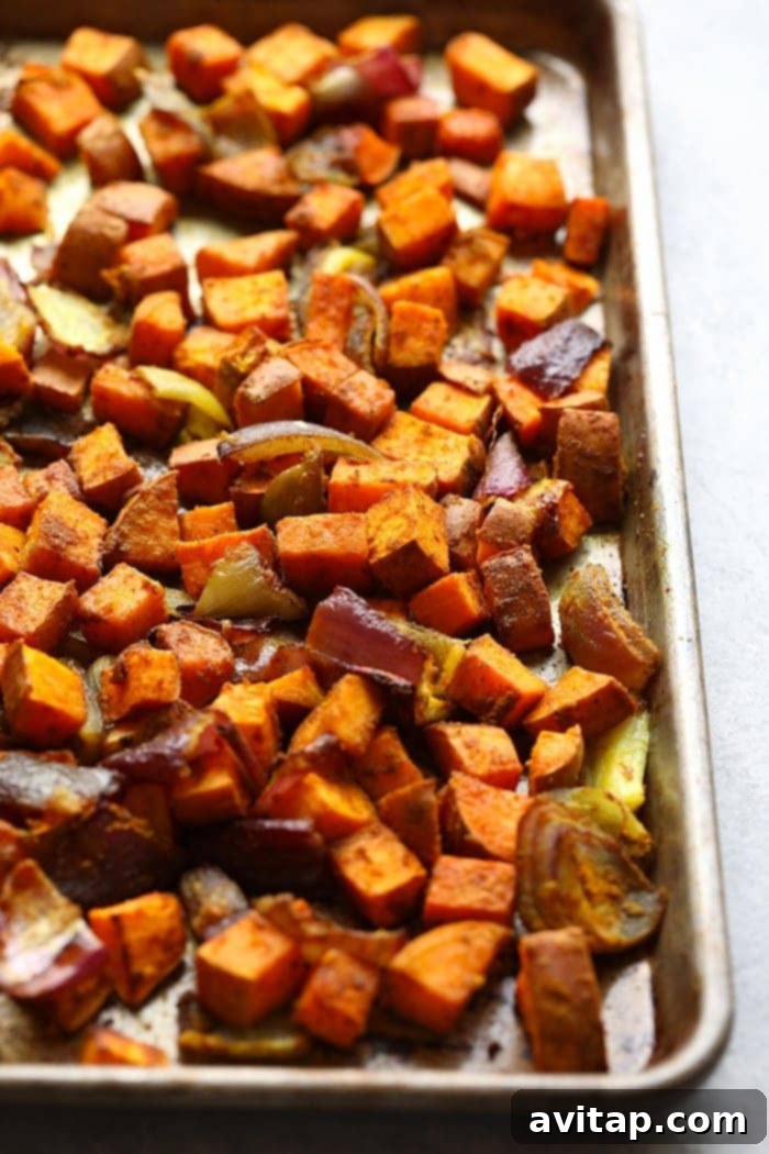 Close-up of roasted sweet potatoes, perfectly caramelized and seasoned, ready for a buddha bowl.