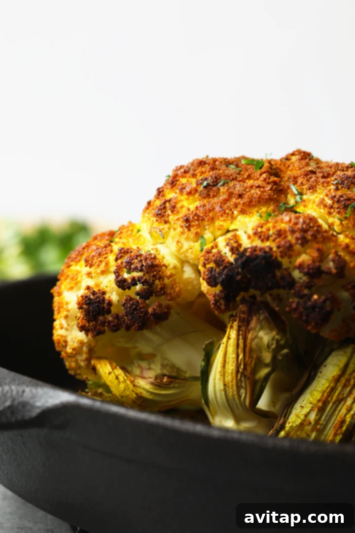 Perfectly roasted golden cauliflower florets in a cast iron pan, ready for the salad.