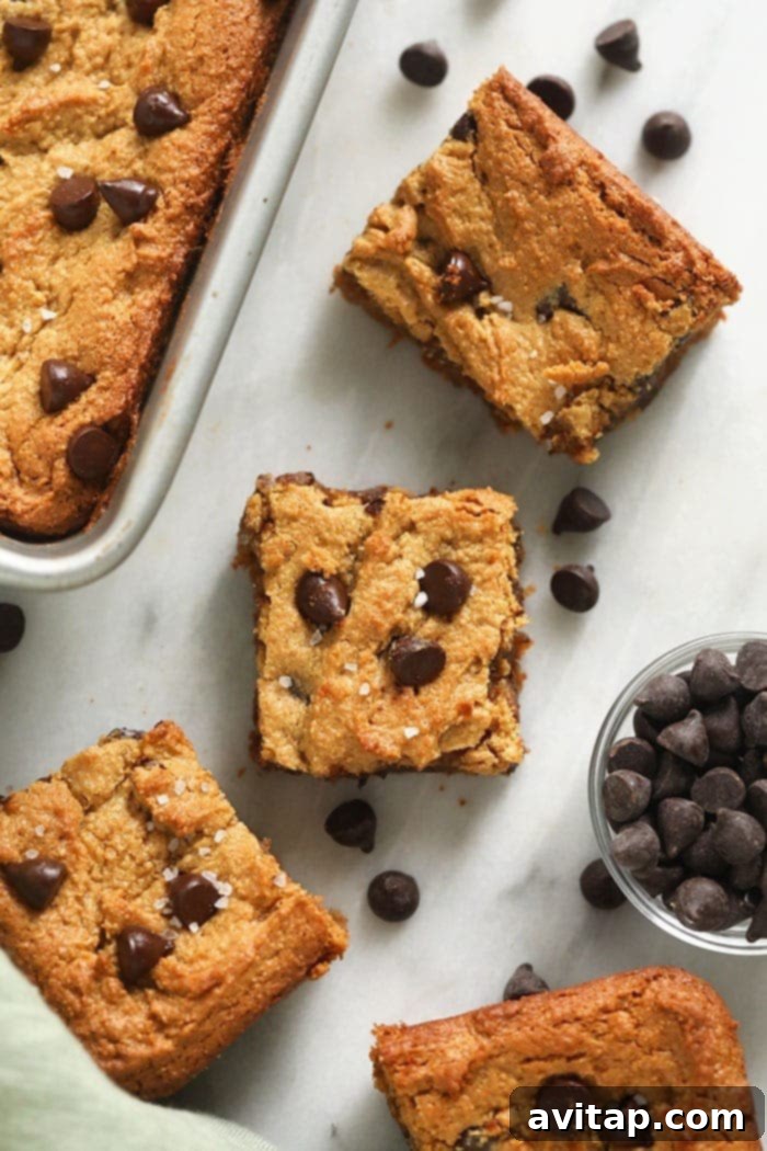 Close-up of a single, perfectly baked flourless blondie adorned with melted dark chocolate chips.