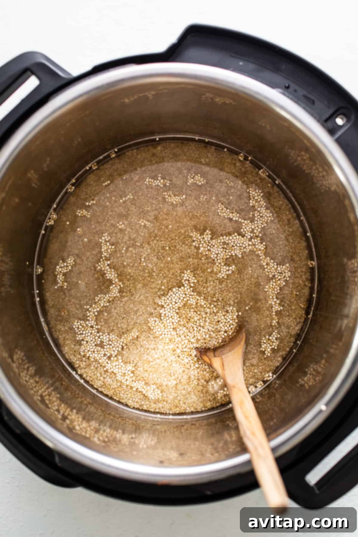 Effortless Instant Pot Quinoa 5 Quinoa and liquid inside an Instant Pot, ready for cooking.