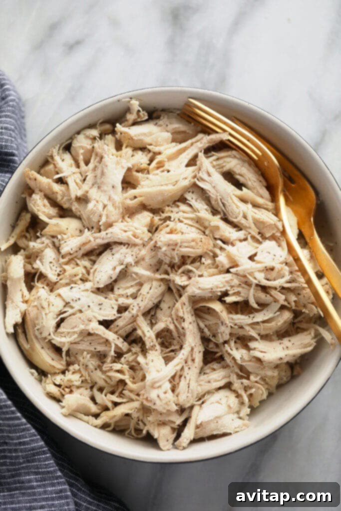 Freshly made Instant Pot shredded chicken stored in an airtight container, ready for seamless meal prepping throughout the week.