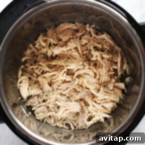 Instant Pot Shredded Chicken in a serving bowl, showcasing its tender texture and readiness for various dishes.