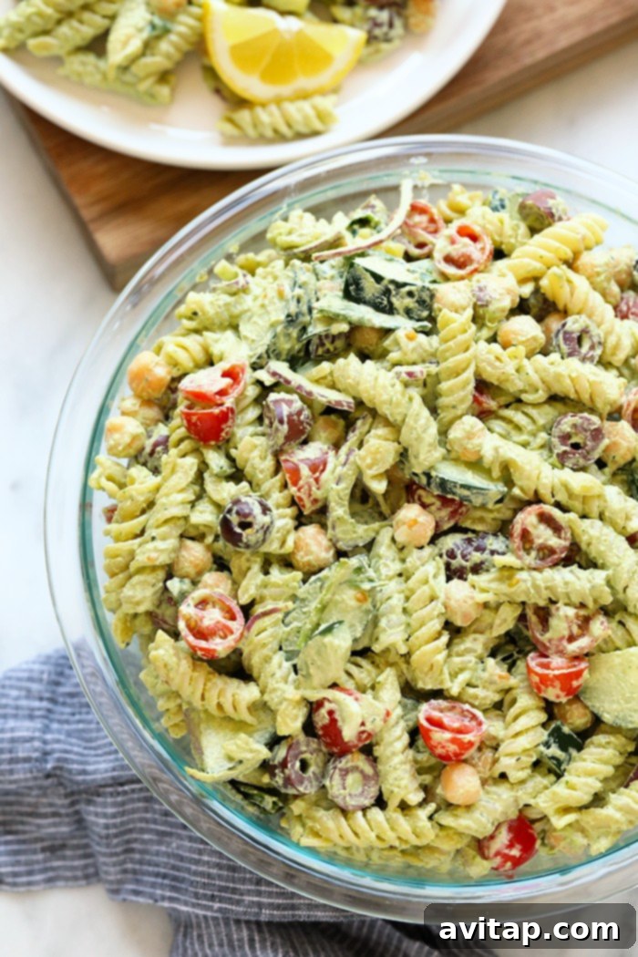 A refreshing and healthy vegan pesto pasta salad, ideal for any meal or gathering. A bowl of fresh vegan pesto pasta salad, perfectly chilled and ready for enjoyment on a sunny day.