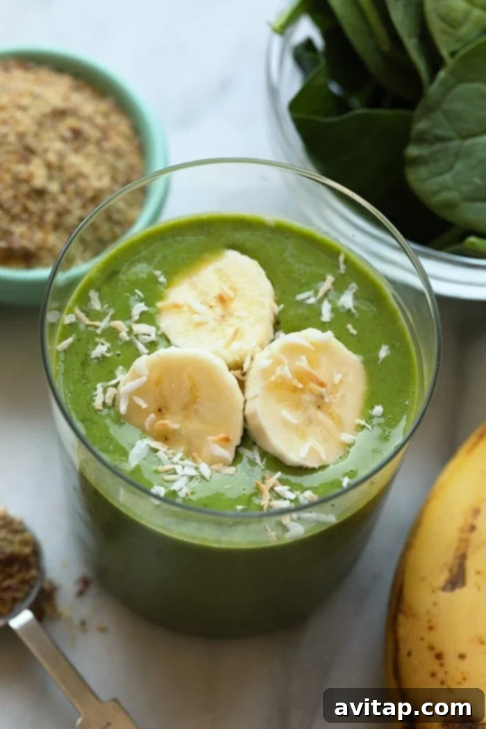 Enjoy a refreshing and nutritious Banana Matcha Smoothie for a perfect start to your day. Close-up of a perfectly blended Banana Matcha Smoothie in a tall glass, ready to be enjoyed as a healthy breakfast.