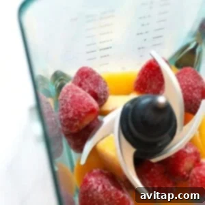 Frozen fruit, rosé, and other frosé ingredients in a blender, ready for blending.