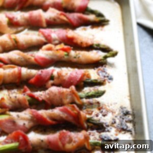 This bacon wrapped asparagus is a fun way to dress up your favorite veggie! You can make this bacon wrapped asparagus recipe for a tasty side dish for dinner or you can make them for an easy appetizer for a party. Either way, they're delicious!