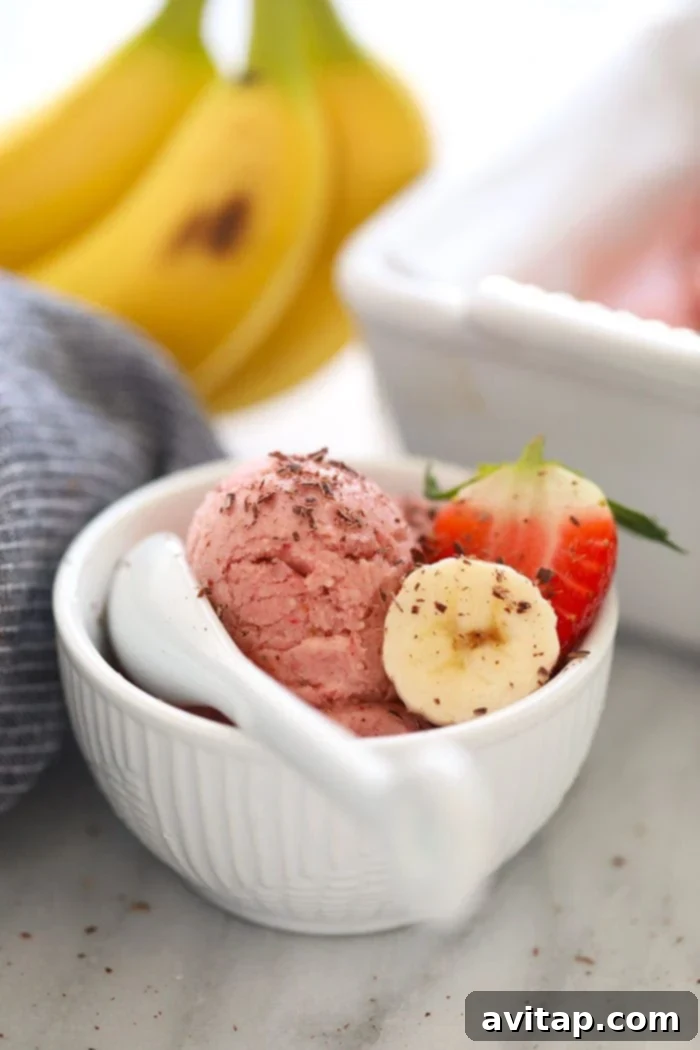 A vibrant bowl of Protein Strawberry Banana Nice Cream, ready to be enjoyed.