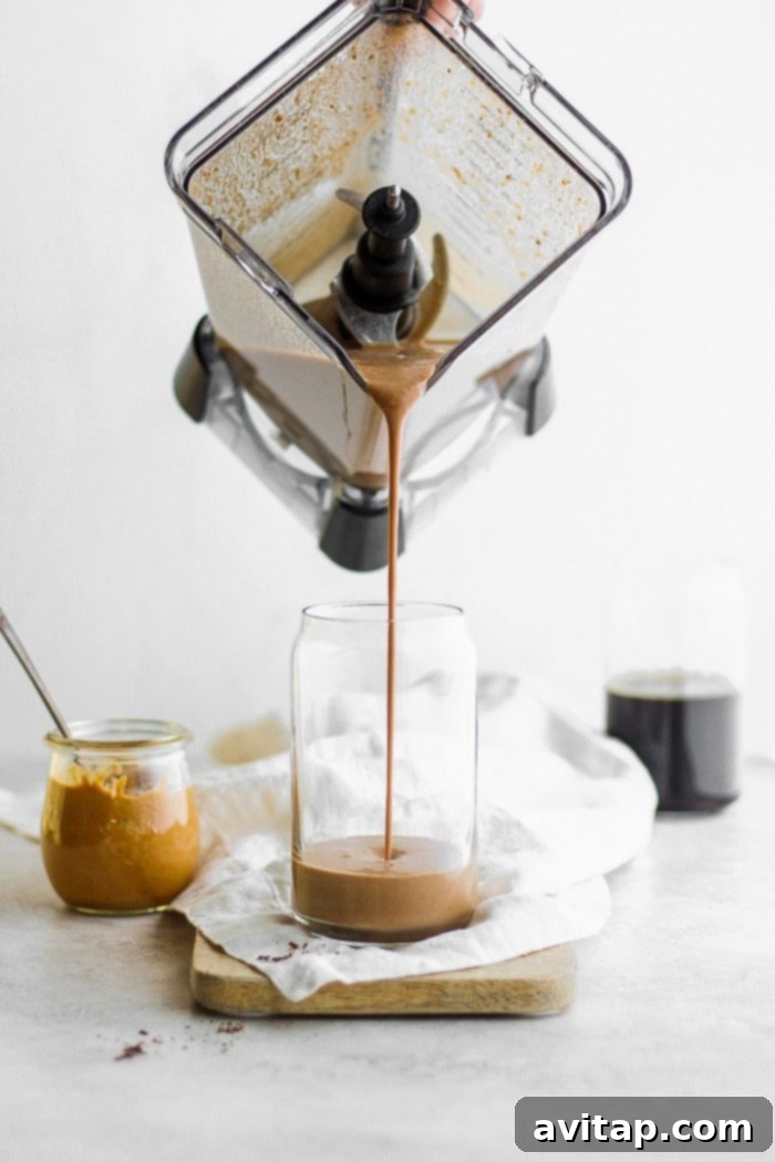 A protein smoothie being poured into a glass