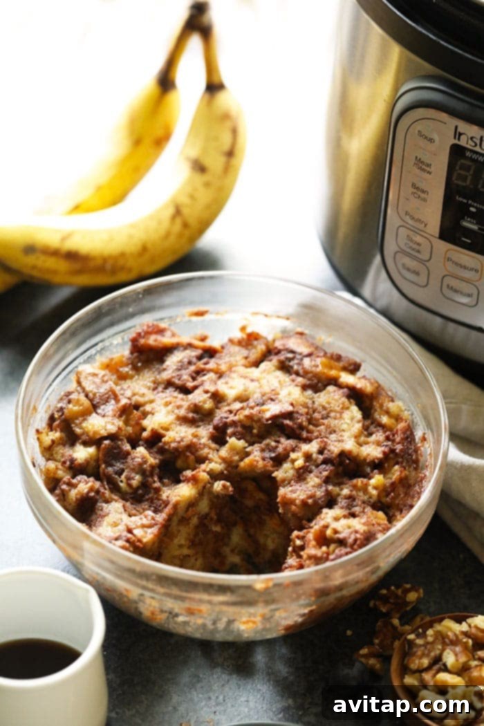 A serving of warm, golden French Toast Bake in a bowl, showcasing its rich texture, garnished with fresh berries and a sprinkle of powdered sugar.