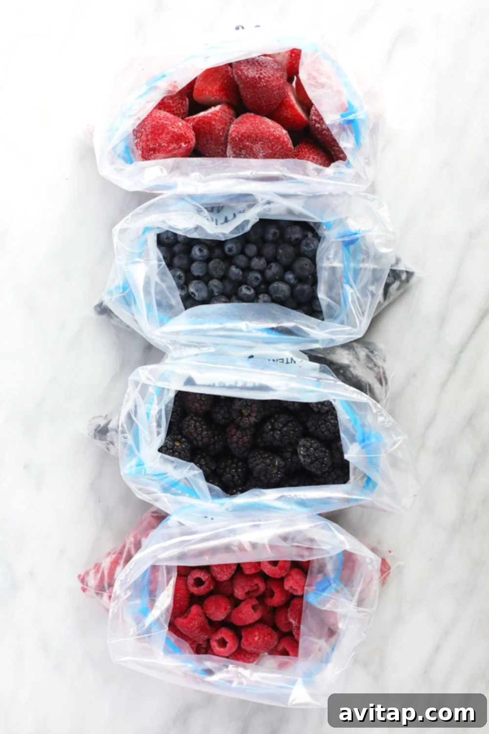 Assortment of frozen berries in Ziploc bags, organized and ready for storage in the freezer.