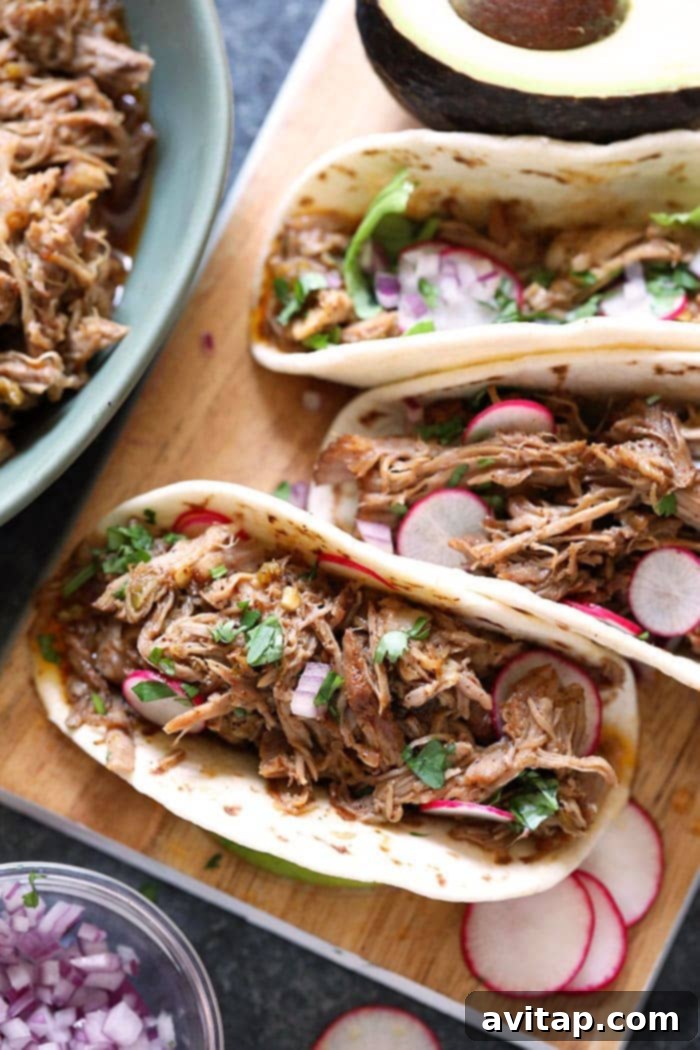 Crispy Instant Pot Carnitas Tacos served with fresh toppings like cilantro and onions