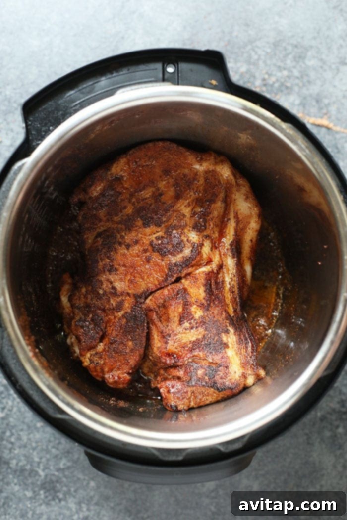 Pork shoulder searing to a golden brown in the Instant Pot