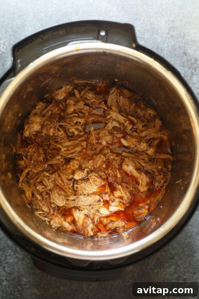 Perfectly shredded Instant Pot Carnitas, ready to be crisped under the broiler