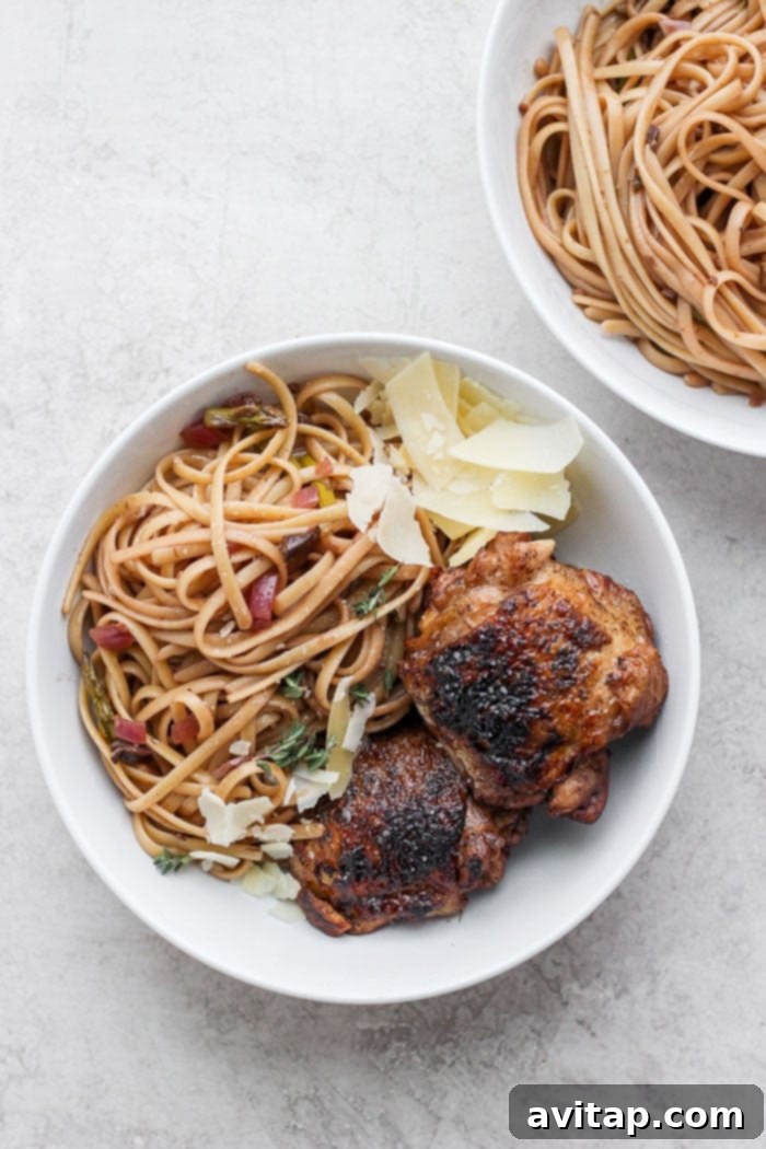 Plated balsamic roasted chicken pasta with a fork