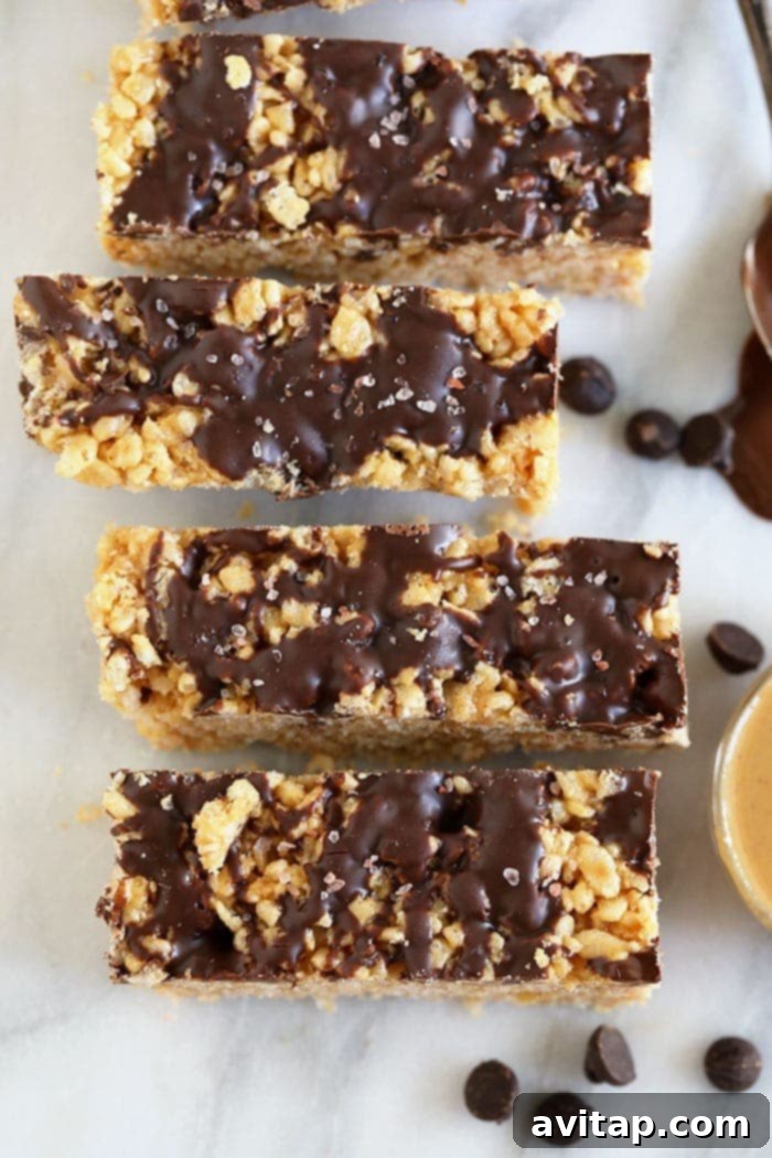 Wholesome Peanut Butter Crunch Bars 2 Delicious and healthy peanut butter rice crispy bars, perfectly drizzled with chocolate and ready for a no-bake treat without marshmallows.