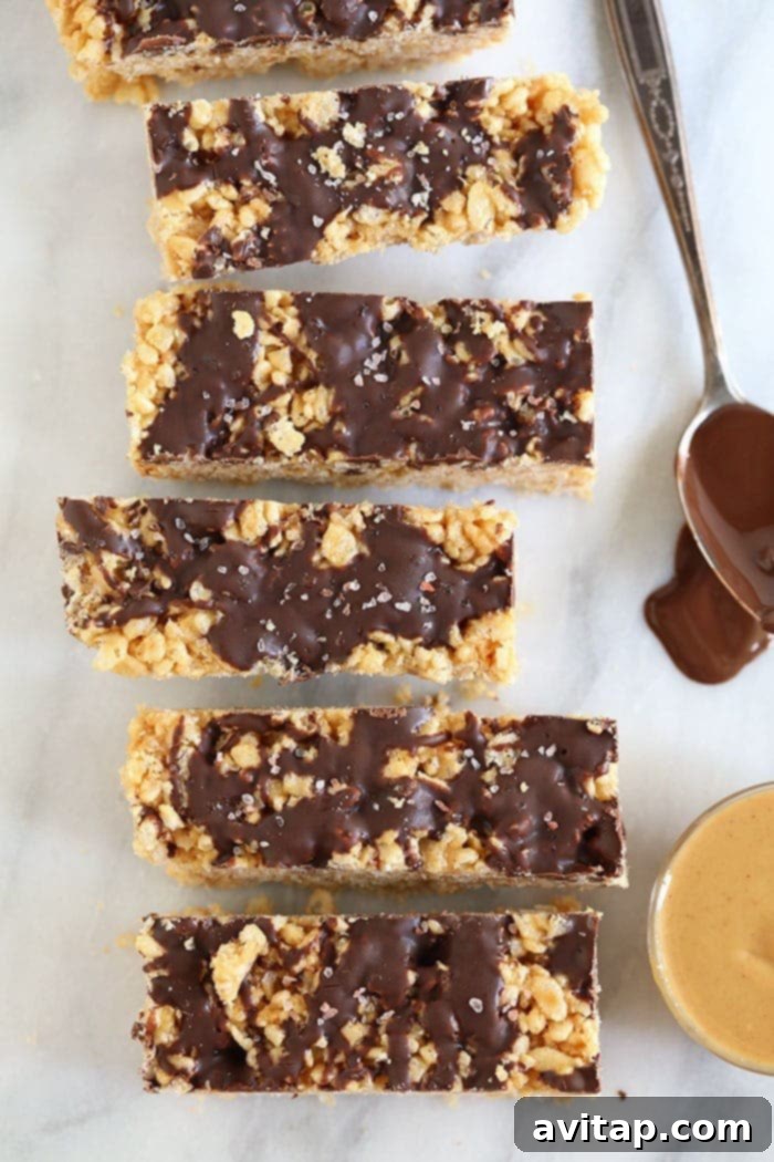 Wholesome Peanut Butter Crunch Bars 5 Perfectly sliced healthy peanut butter rice krispie bars with elegant chocolate drizzle, arranged neatly and ready for serving or long-term freezer storage.