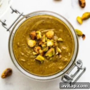 Pistachio nut butter in a glass container.