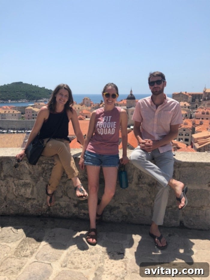 Dubrovnik City Walls: A Must-See Croatian Landmark People walking along the ancient city walls of Dubrovnik, Croatia, overlooking the sea and historic buildings.
