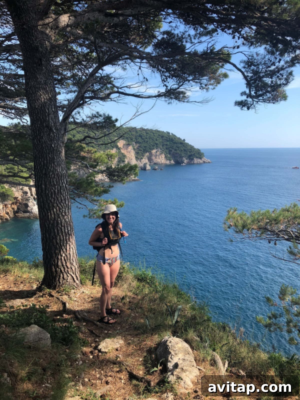 Hiking in Croatia: Trails with Breathtaking Adriatic Views A hiker on a scenic trail in Croatia, overlooking a panoramic view of the coastline and islands.