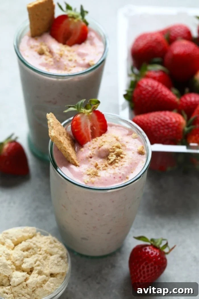 What’s better than cheesecake for breakfast? NOTHING! You’re going to love this Strawberry Cheesecake Protein Smoothie. It’s made with just a few simple ingredients: frozen strawberries, bananas, vanilla protein powder, Greek yogurt, and almond milk. Don’t forget to crush some graham crackers on top to really top off this healthy protein smoothie recipe! Healthy strawberry cheesecake protein smoothie with graham cracker topping