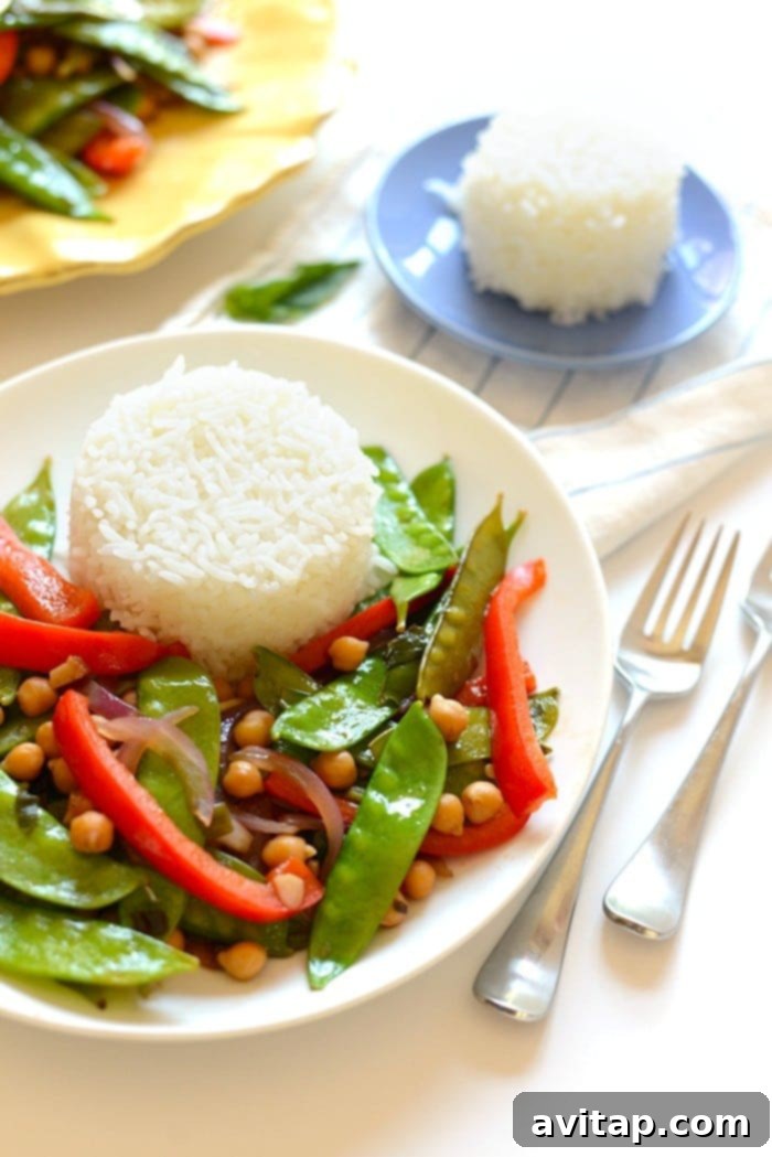 A plate of Thai Basil Veggie Stir Fry with sticky rice.