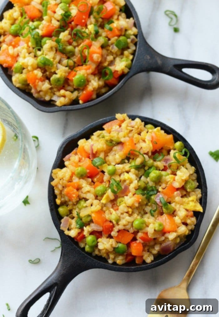 This vegetable fried rice recipe is made with short grain brown rice, tons of veggies, and a protein-boost of eggs for a delicious Asian-inspired meal! Have you ever wondered how to make fried rice taste delicious AND healthy? Make this egg fried rice recipe as a healthy Chinese food option next time you’re craving takeout. Healthy vegetarian fried rice with brown rice and mixed vegetables