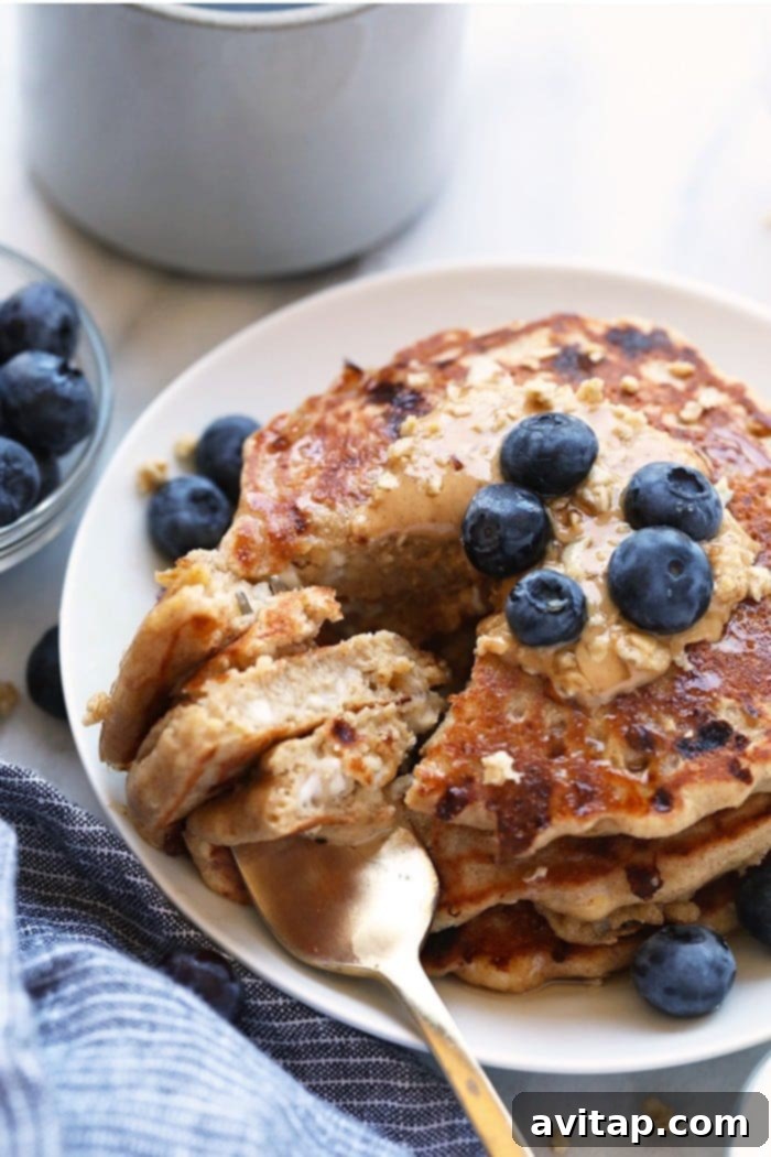 Fluffy cottage cheese protein pancakes stacked high.