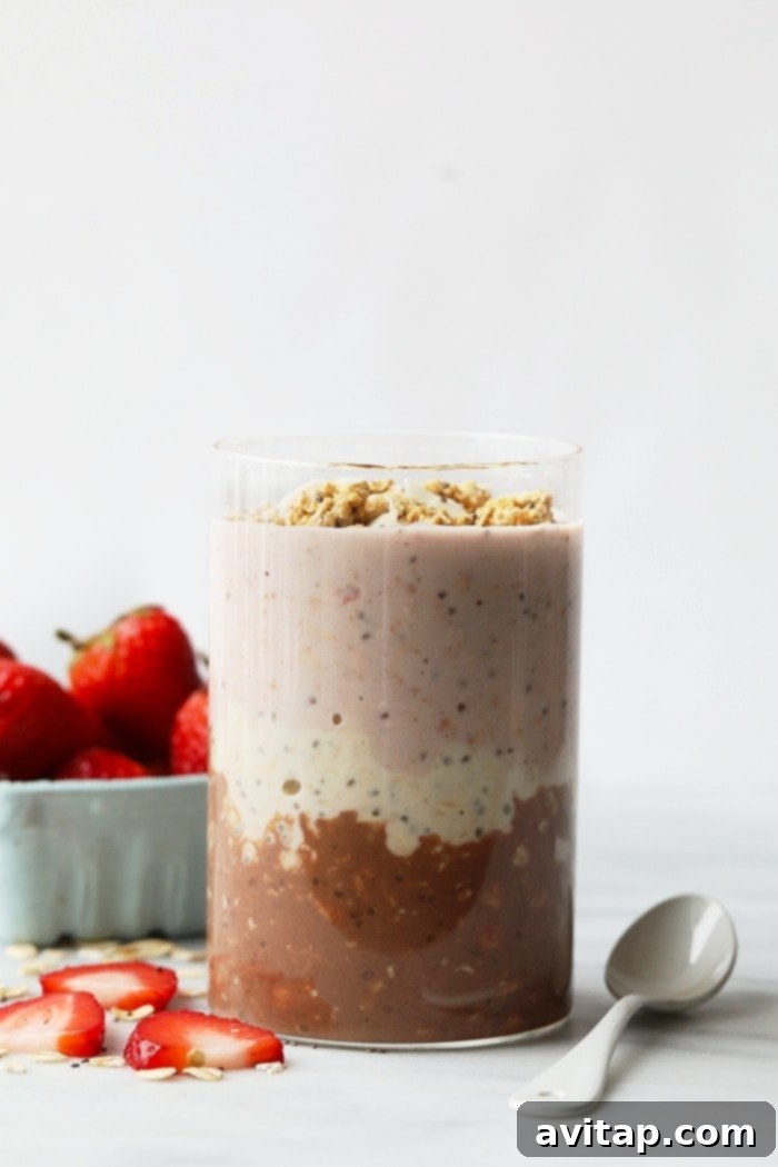 Three layers of Neapolitan overnight oats in a jar.