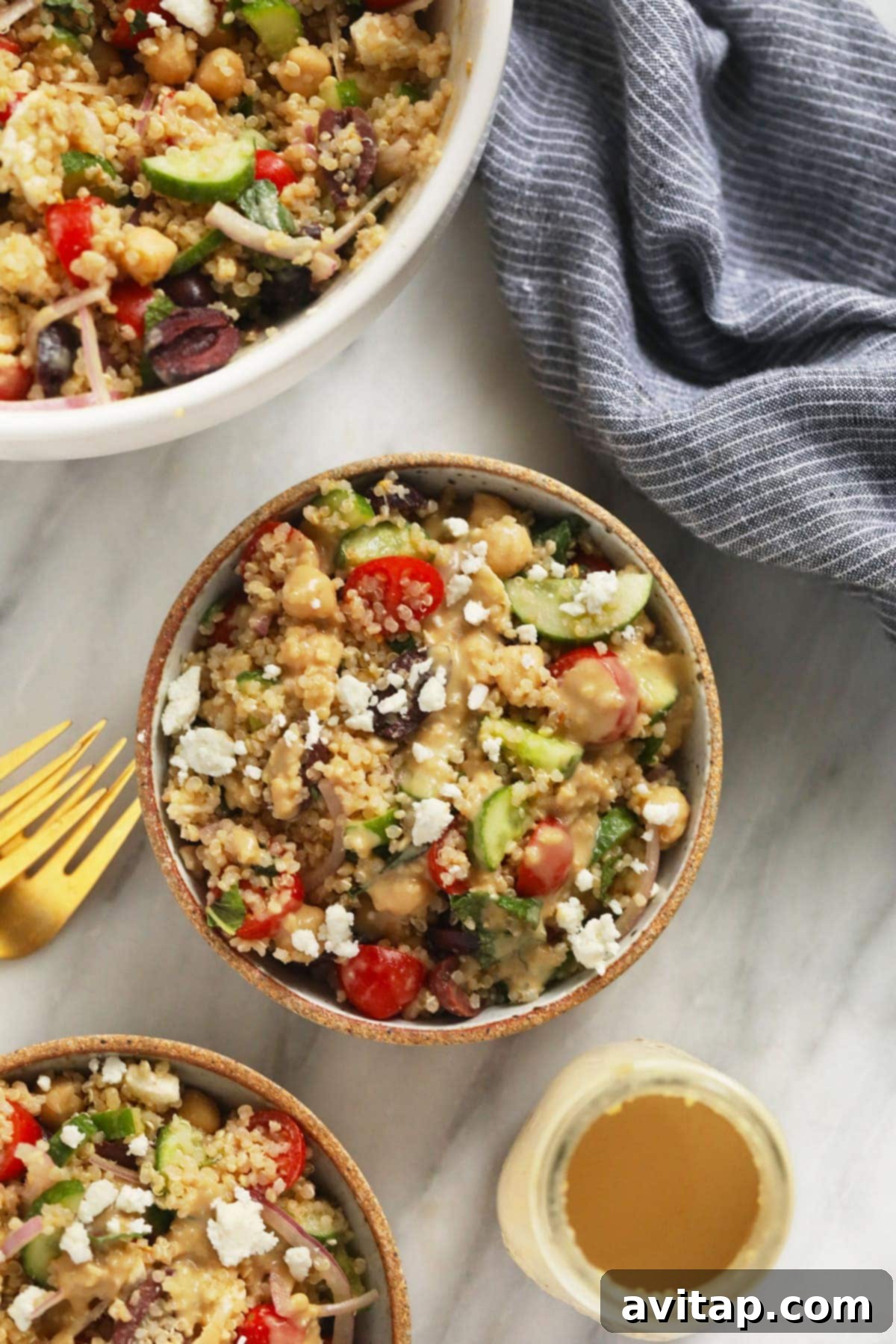 Two bowls of Mediterranean Quinoa Salad, perfectly portioned and ready for serving, showcasing their appetizing presentation.