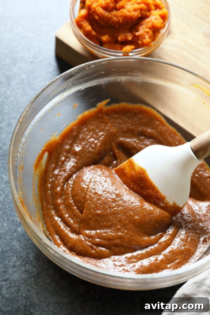 Close-up view of the creamy pumpkin almond butter freezer fudge batter in a bowl, showing its smooth texture