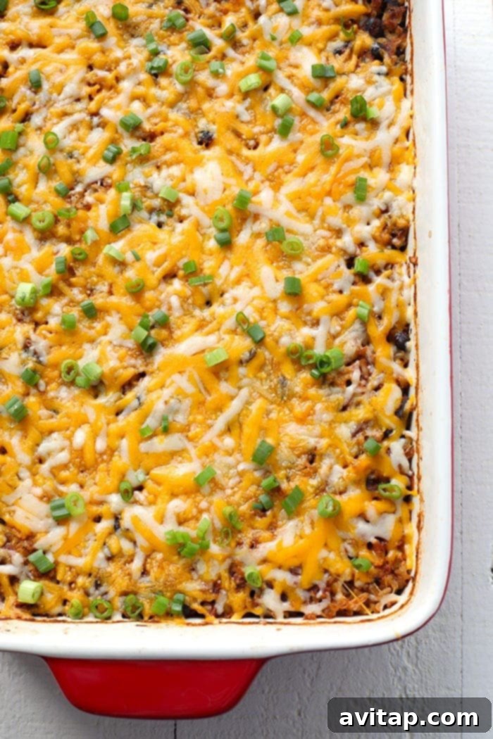 Close-up of a bubbling Southwestern Chicken Casserole fresh from the oven, topped with golden-brown melted cheese.
