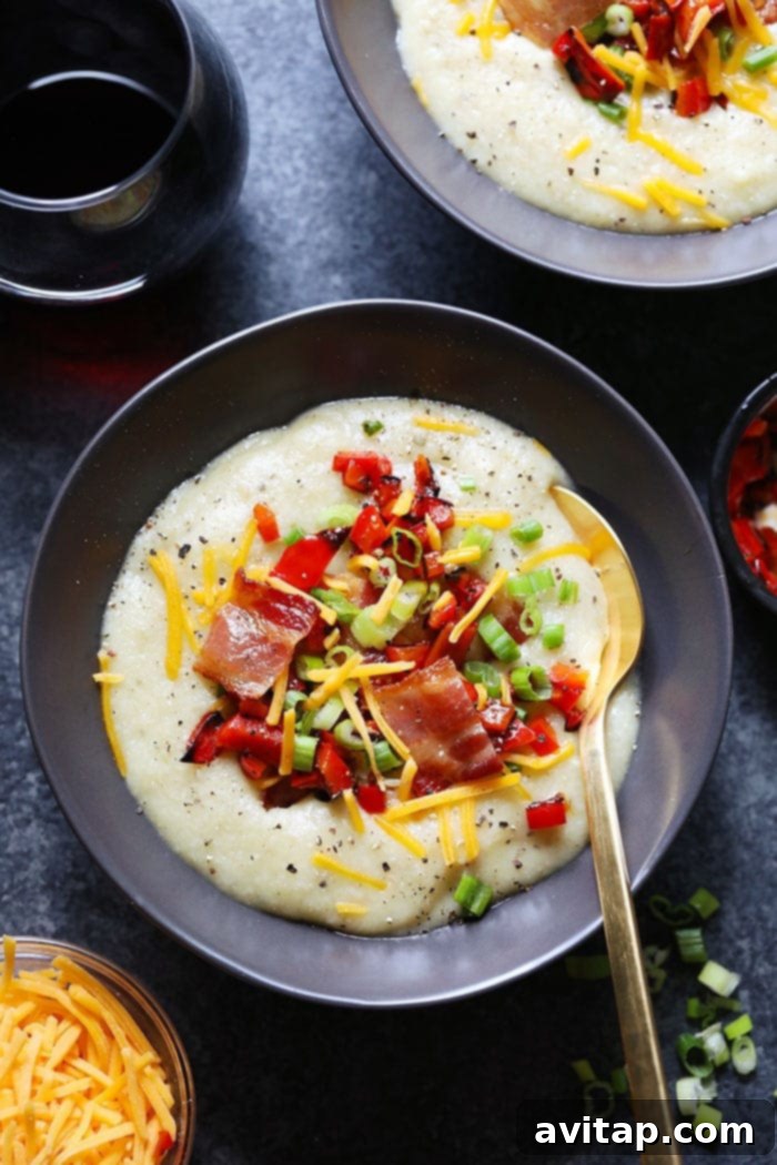 Loaded Cauliflower Potato Soup in a bowl, generously topped with crispy bacon, fresh green onions, and melted cheese