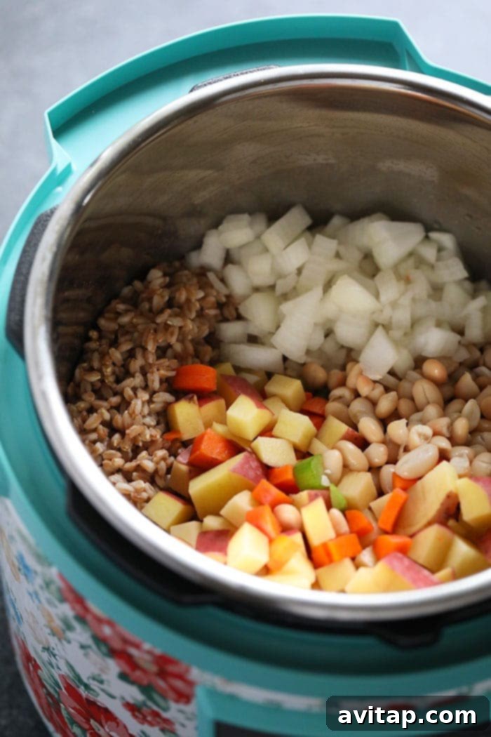 All the vibrant ingredients for Tuscan Turkey Soup ready in the Instant Pot for cooking. Instant Pot filled with soup ingredients, ready to be cooked