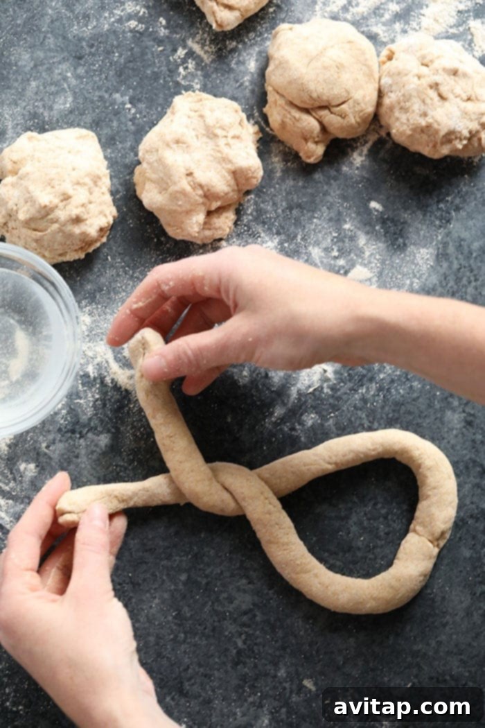 Wholesome Homemade Soft Pretzels 6 Pretzel dough being rolled into a long rope, ready for shaping.