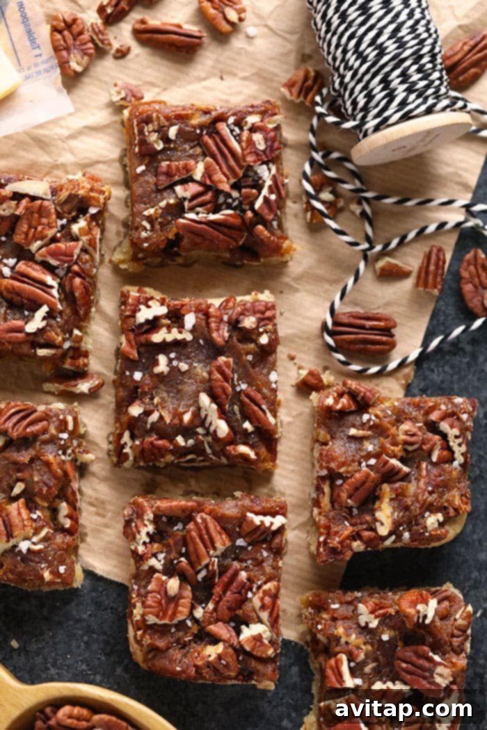 Freshly Baked and Cut Pecan Pie Bars Close-up of freshly baked and perfectly cut easy pecan pie bars, highlighting their rich texture and golden brown crust.