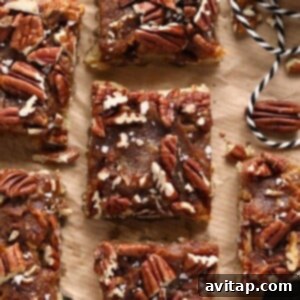 Gooey Pecan Pie Bars 2 Easy pecan bars on a piece of parchment paper.