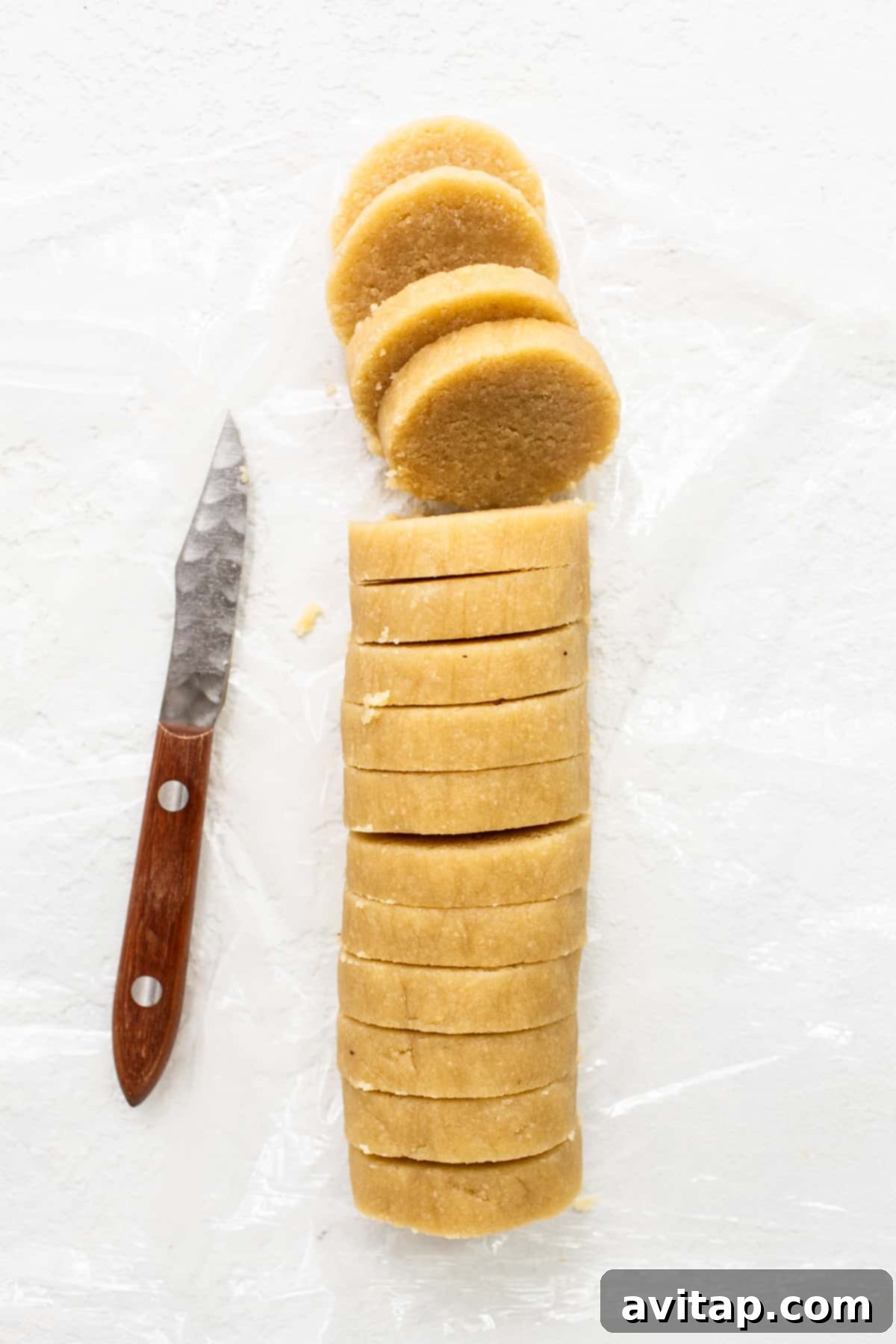 Perfectly sliced rounds of chilled almond flour cookie dough, ready for baking.