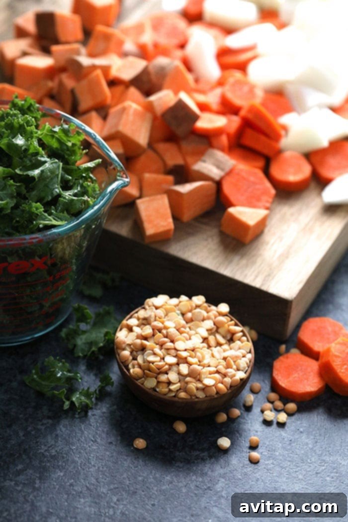 Sweet potatoes and lentils – the hearty foundation of this vegan curry. Close-up of cubed sweet potatoes and red lentils, key ingredients for the curry.