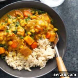 A vibrant bowl of Instant Pot Sweet Potato Vegan Curry, beautifully garnished and ready for serving.