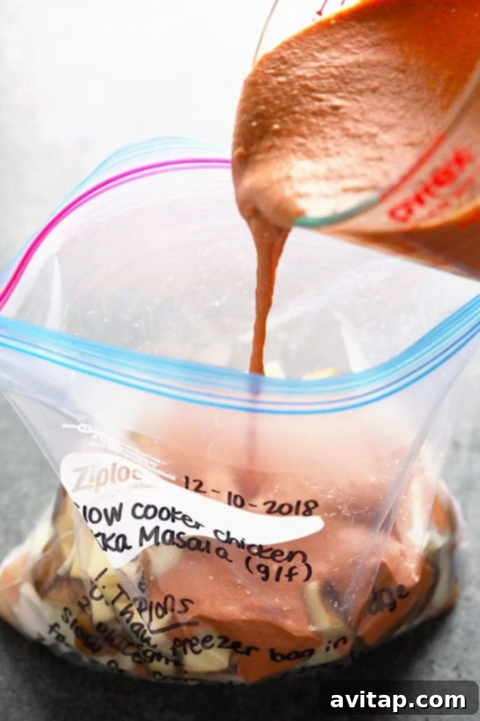 Efficient Freezer Meal Prep: Ingredients into the Bag Preparing freezer meals by adding ingredients into a large Ziploc bag