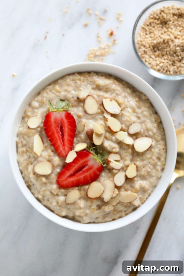Steel cut oats in a bowl topped with strawberries and almonds