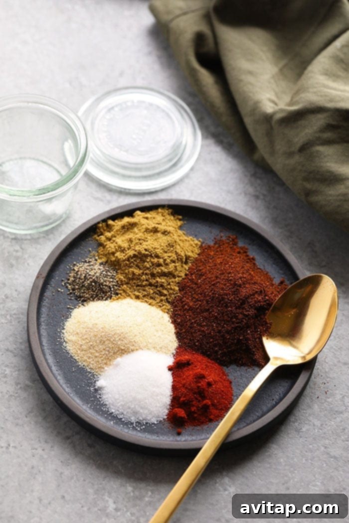 Simple homemade fajita seasoning: 6 ingredients, 5 minutes, ideal for veggies, chicken, steak, and soup. Close-up of homemade fajita seasoning on a small white plate, ready for use.