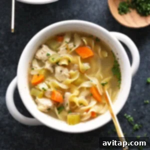 Delicious slow cooker chicken noodle soup, steaming and ready to eat.