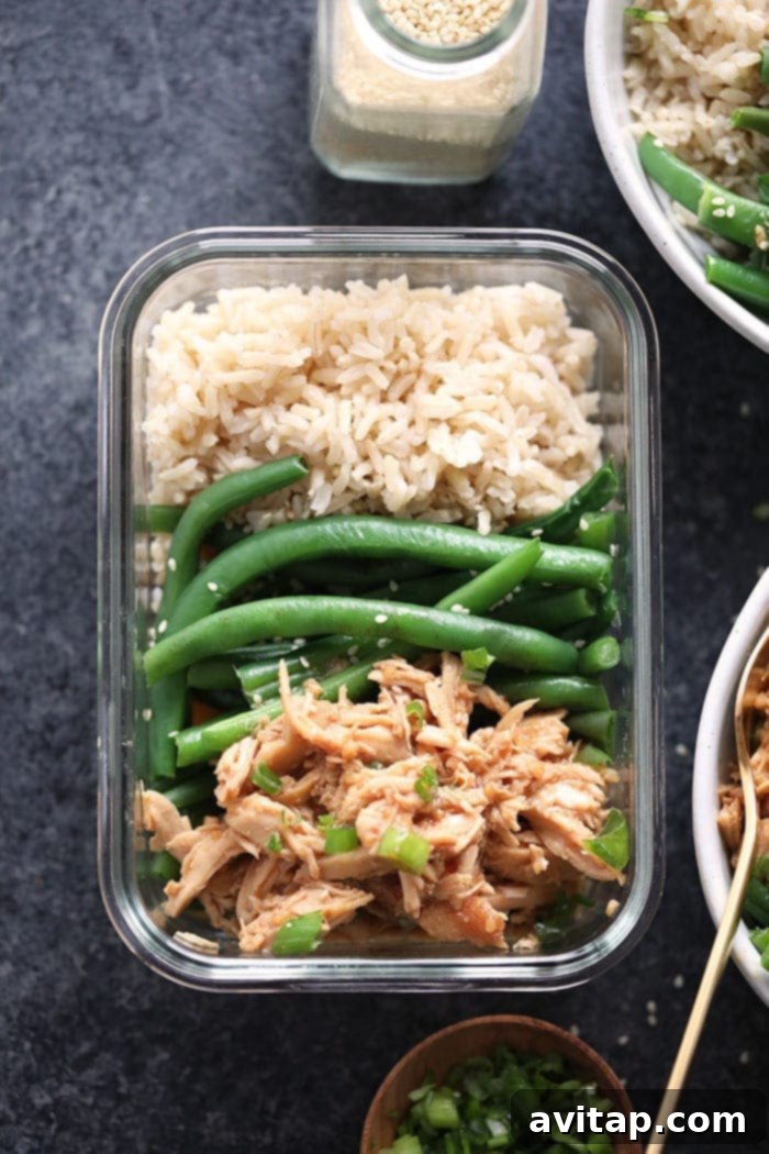 Make our slow cooker honey garlic chicken recipe with 5 simple ingredients. This chicken comes out so saucy and is so easy to make. Just set it and forget it in your slow cooker! Honey garlic chicken with rice and green beans arranged neatly in a meal prep container, ready for a healthy lunch.